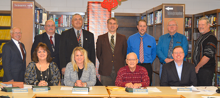Board members pose together in the library