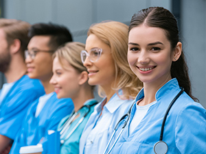 Health students in a row wearing blue jackets