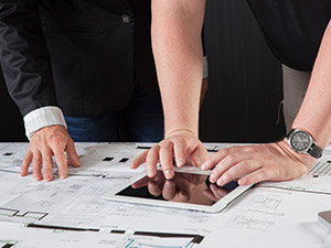 two people reading blueprints