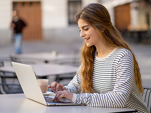 Woman working on a computer outside