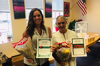 Teacher of the Month Diana Lopez and Employee of the Month Callie Slade holding their awards