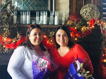 Anna Grijalva and Aracely Caballero holding flowers