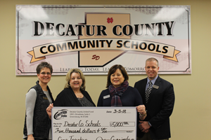 Decatur County Community Schools. Staff holding check for $5,000.