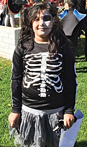 Spooky Story Contest Winner in her skeleton costume