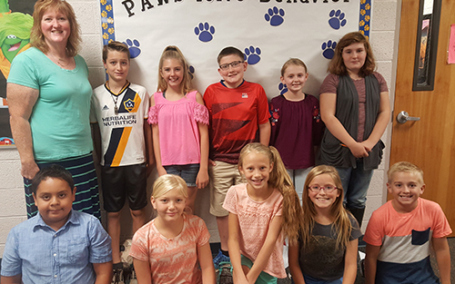 Student Council members posing together with a teacher