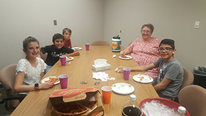 April outstanding students eat pizza with Principal Debbie Muder