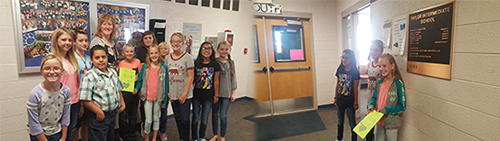 Student council members accept thank you cards and students pose with thank you cards