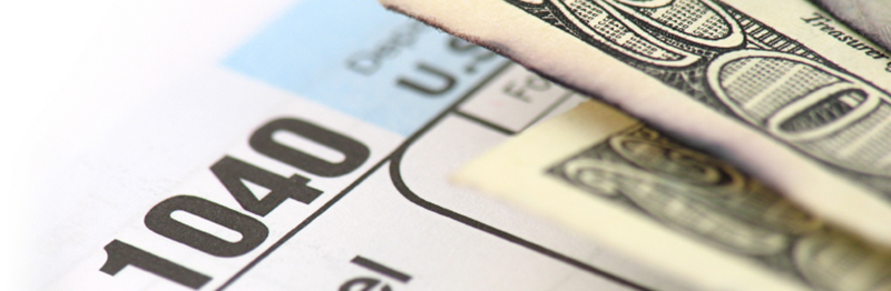 $20 bill and tax forms