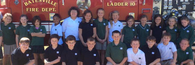 Students stand in front of a fire engine