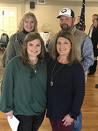 Mattie Sykes poses with her teacher Margaret Bouler and her parents Michael and Amy Sykes