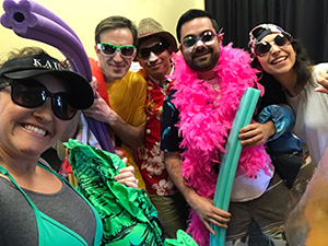 Staff members wearing sunglasses and beach attire