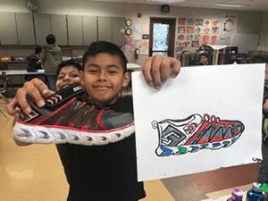 Student poses with his shoe self portrait