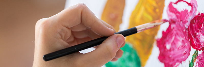 hand of artist with paint brush painting still life picture