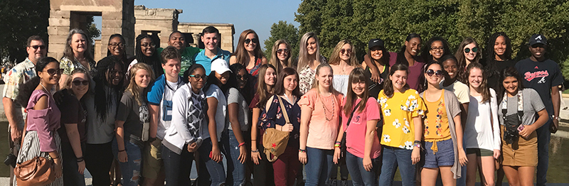 Group of diverse students posing during a field trip
