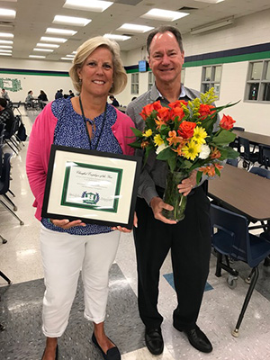 Tracey Constable stands with her award as classified employee of the year