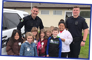 elementary students with police officers