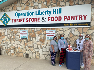 Staff in pajamas outside of Operation Liberty Hill Thrift Store and Food Pantry