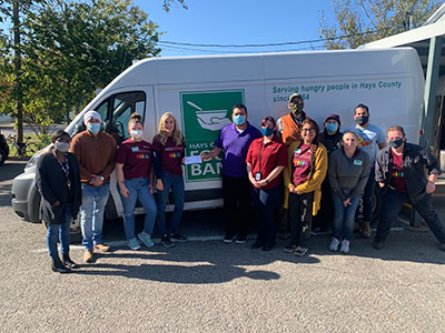 Ki Charter faculty posing in front of Food Bank truck