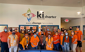 group of adults in orange shirts