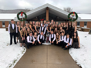 2019 Christmas Show students posing for a picture outside of school building