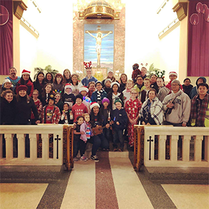 Christmas carolers pose in church