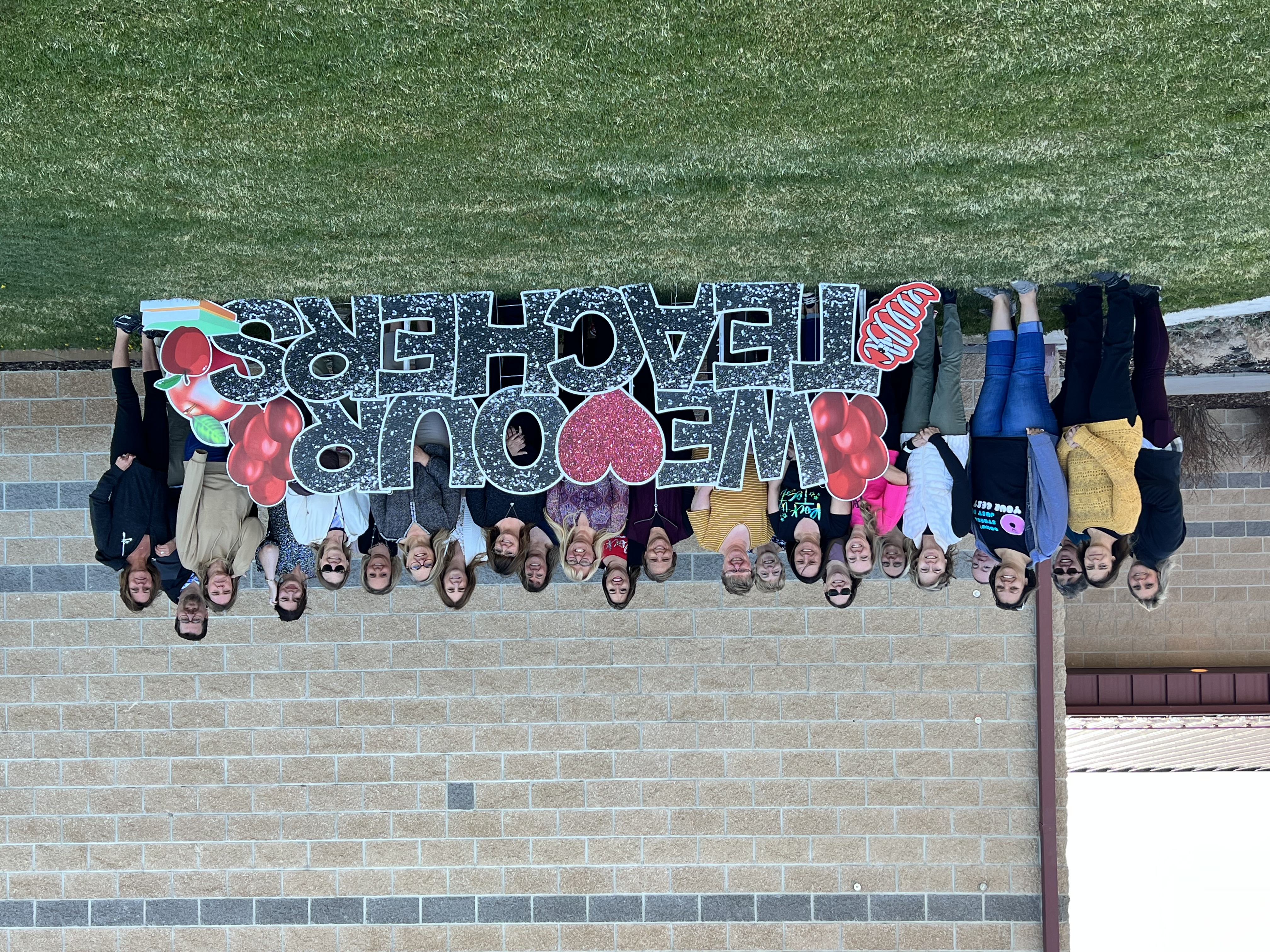 Group of teachers in front of a school