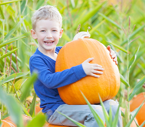 student holding pumpkin