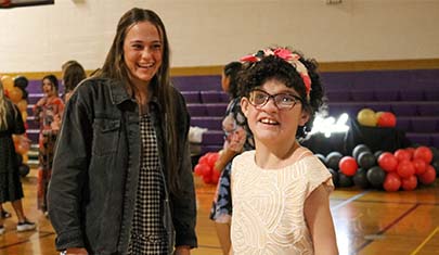 Two girls smiling at dance