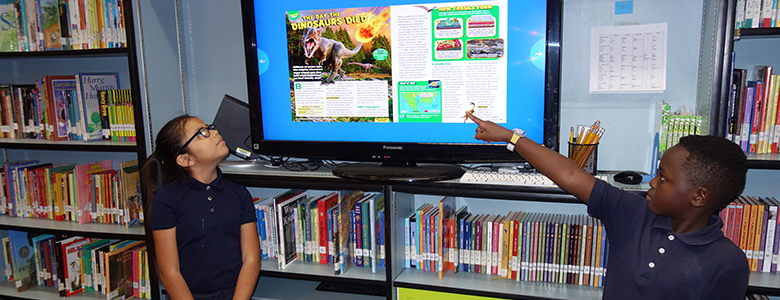 Two students presenting in front of classroom
