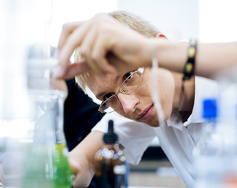 high school student working in the science lab