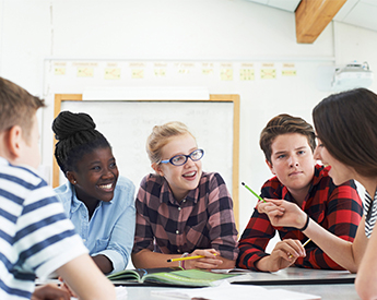 Group of high school students discussing social studies assignment