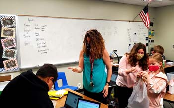 teacher working with students