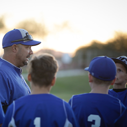 Baseball coach talking to baseball players