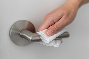 Hand cleaning door handle with sanitizing wipe